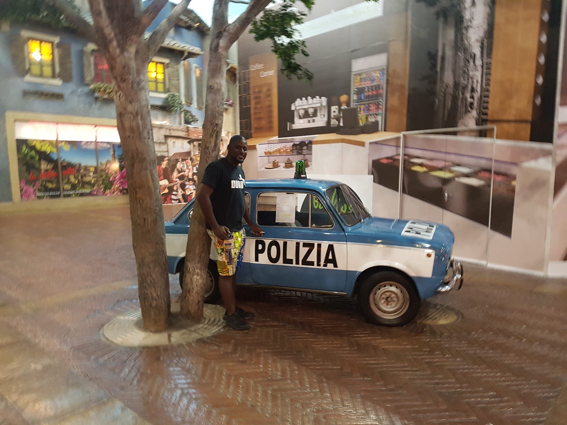 The piazza at night — the detail and scale of it, cobbles underfoot, restaurants on every side