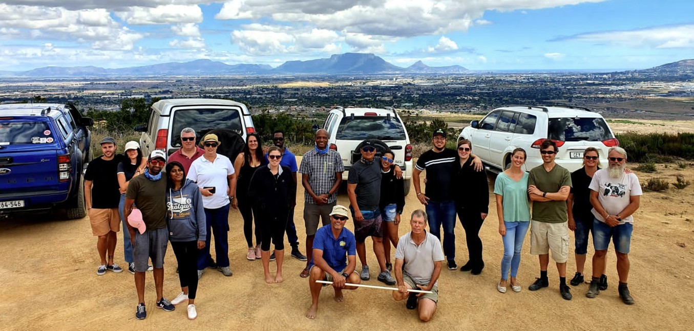The full group on the hillside track — a mix of bakkies and SUVs
