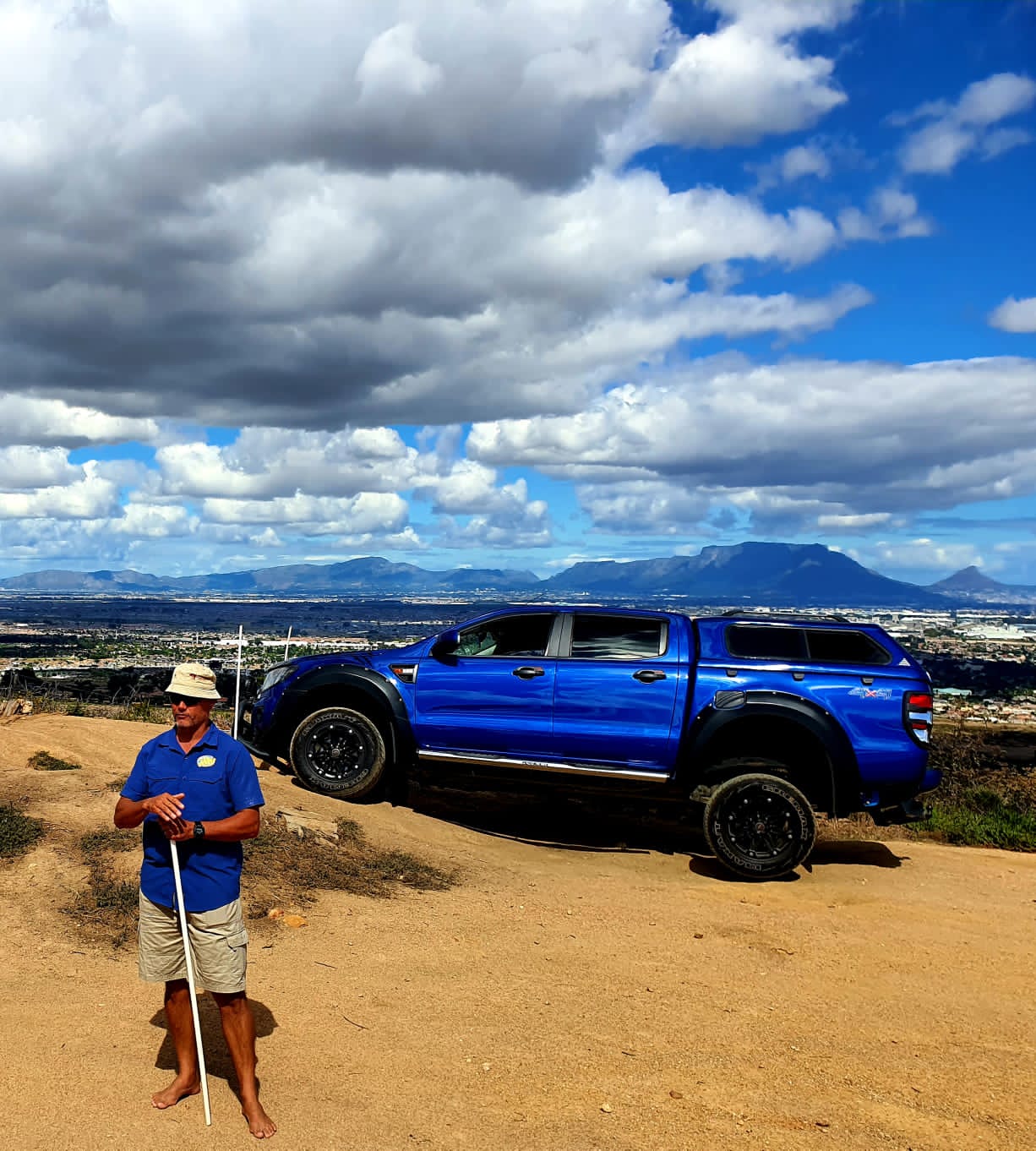 Instructor with the group on the hillside track, Table Mountain visible behind