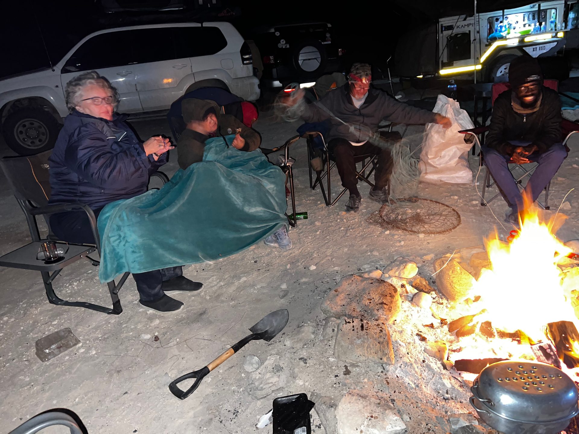 The campfire carrying the group through the first cold night