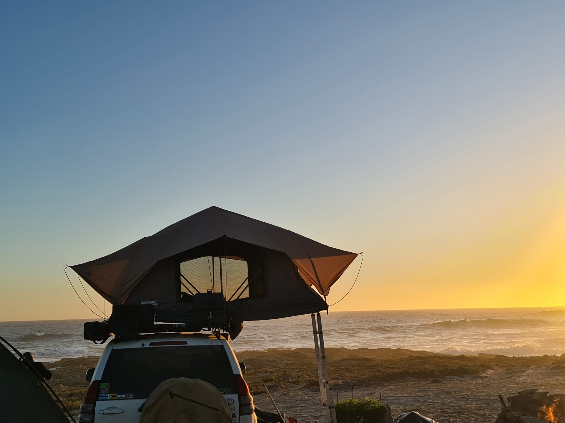 Sunset and a rooftop tent above the Atlantic
