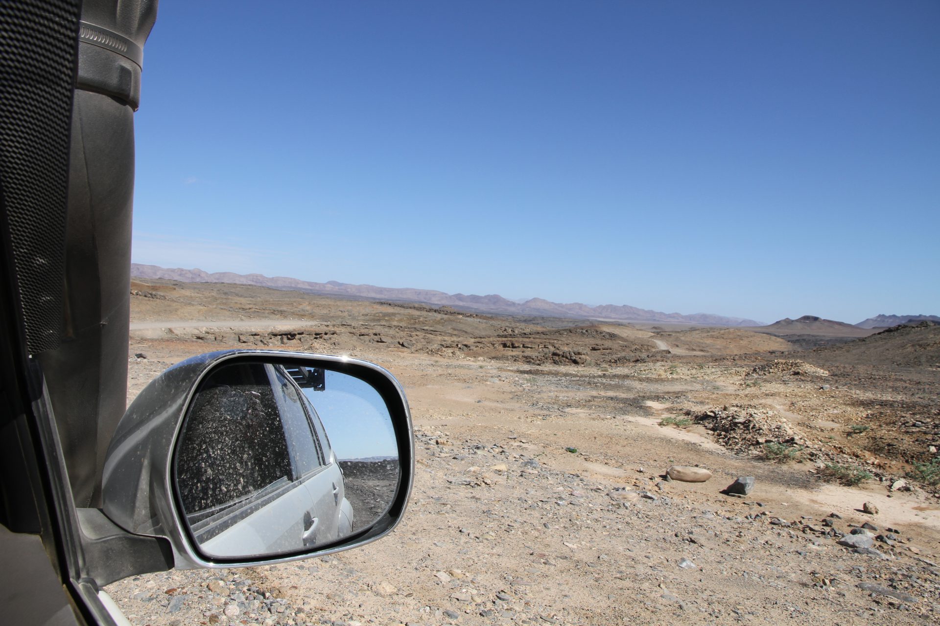Last look at the river before heading south — Namibia in the background, the orange water moving through both sides of everything