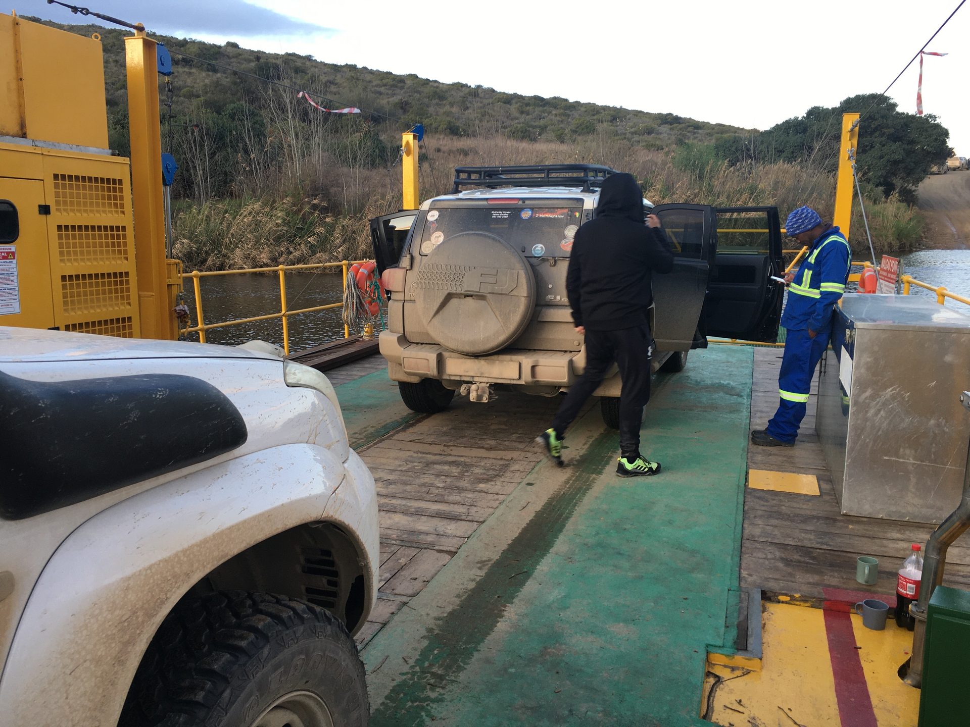Two vehicles crossing the river on the Malgas ferry