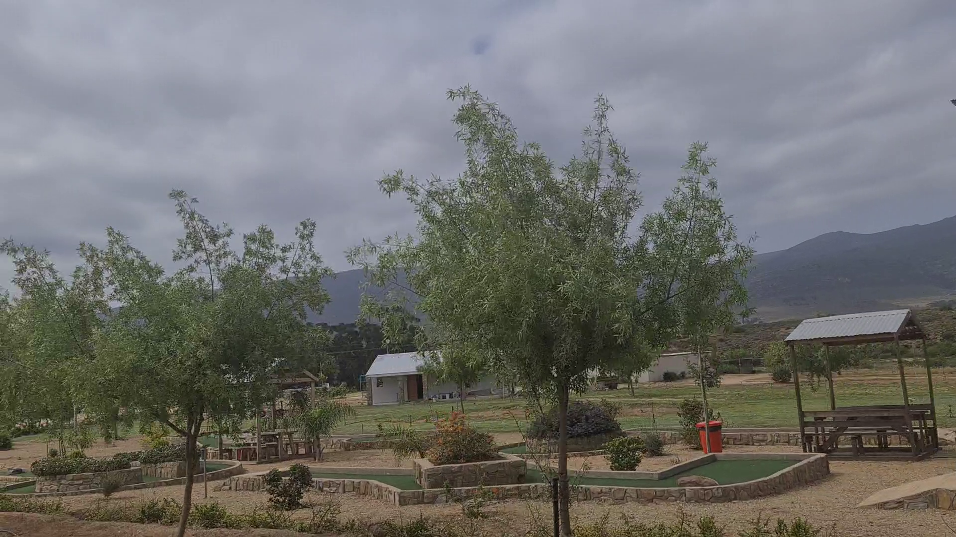Mini golf among the trees with the mountains behind