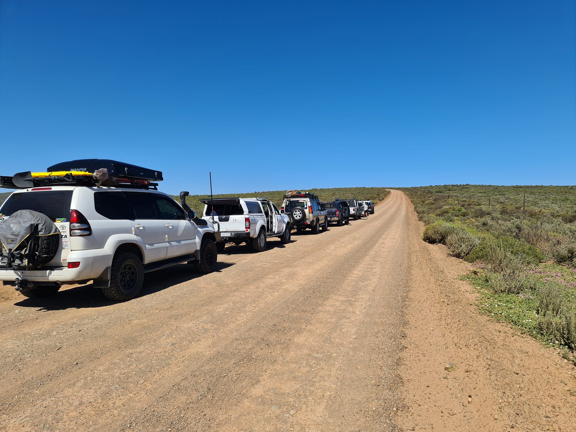 The convoy rolling along the gravel road