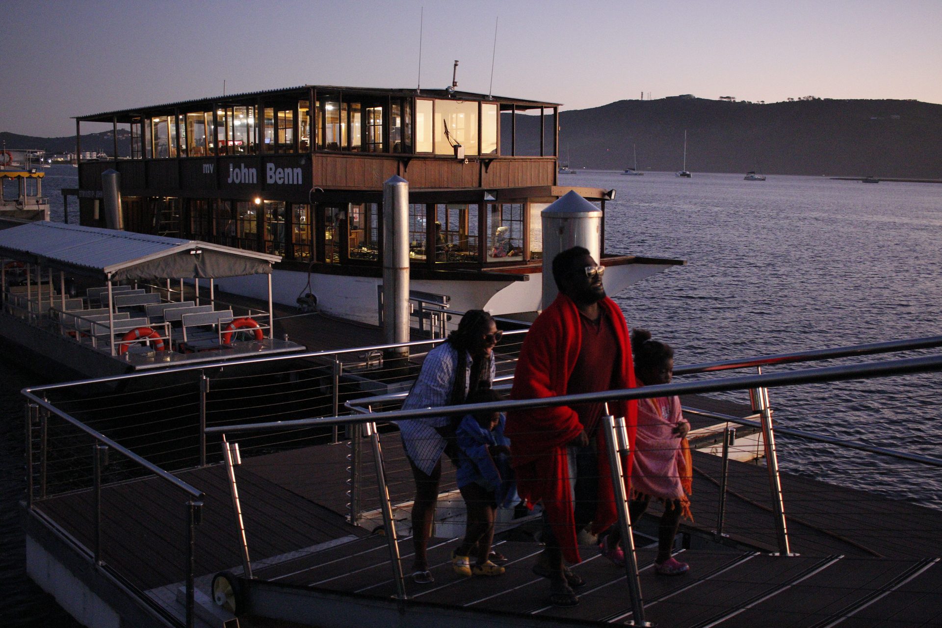 A yacht moving through the busy Knysna waterfront