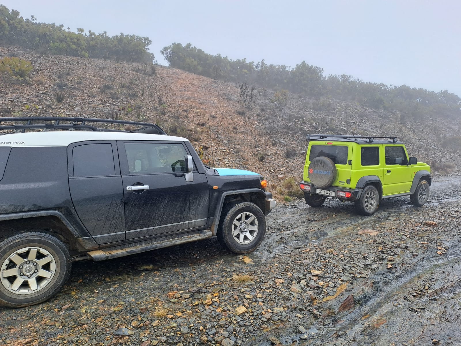 The group pulling in at Rusty Gate — green Jimny making its presence known