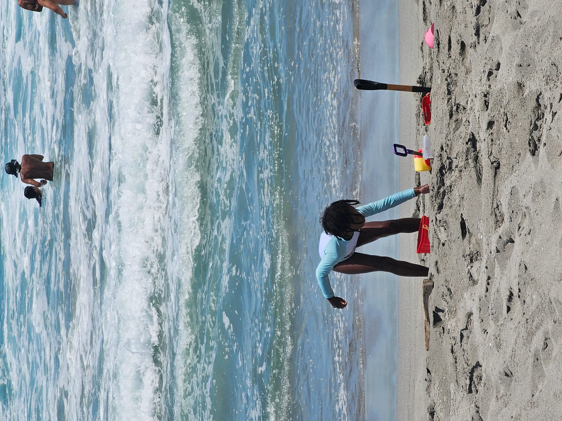Vehicles parked along the sandy shoreline