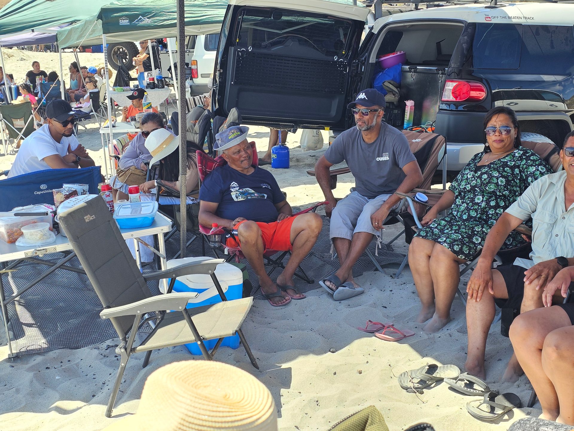 The beach setup tucked between the vehicles
